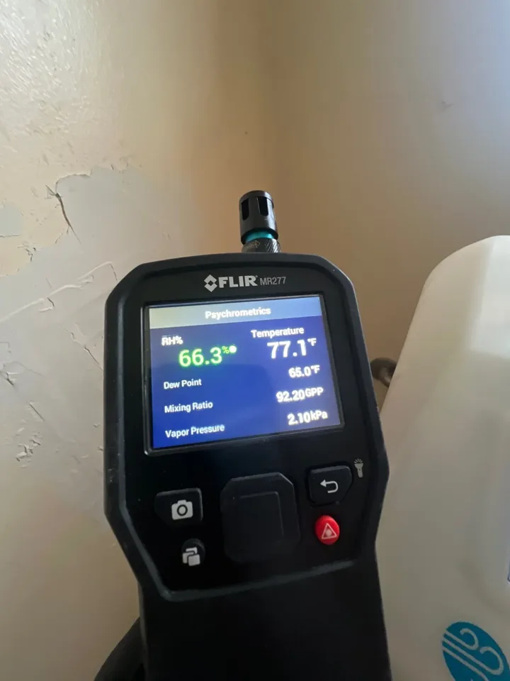 Environmental instrument displaying a reading beside an interior wall.