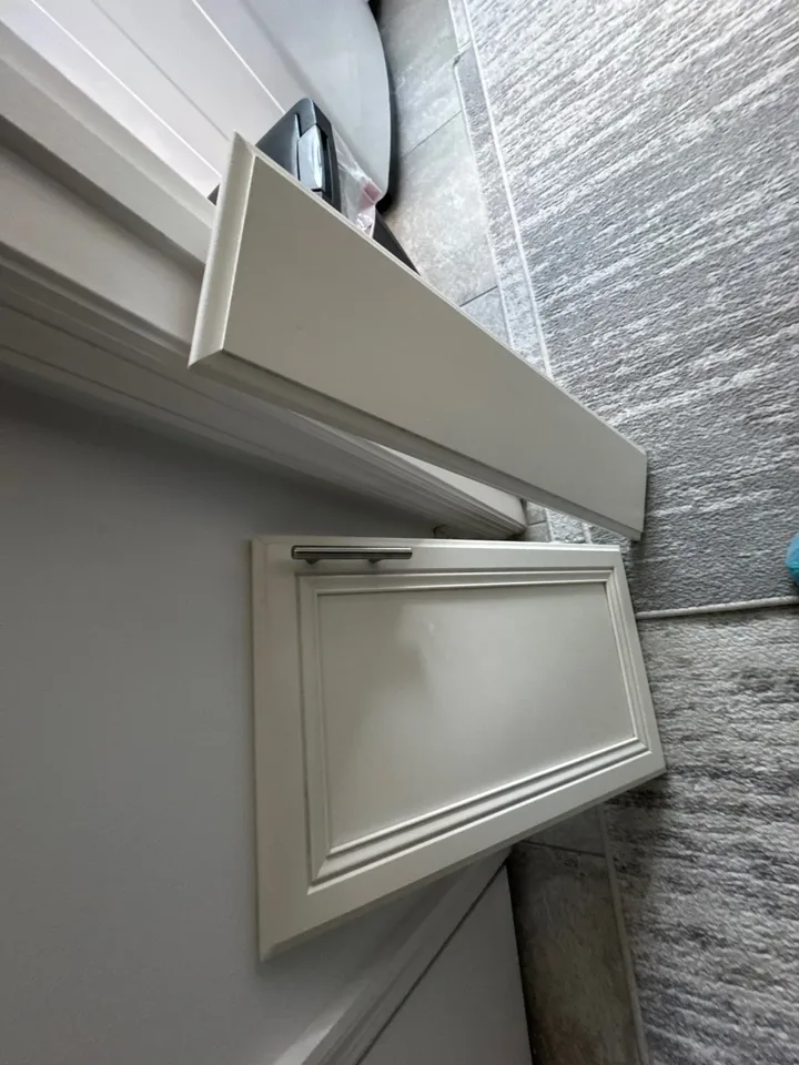 Interior work area with cabinetry and flooring visible.